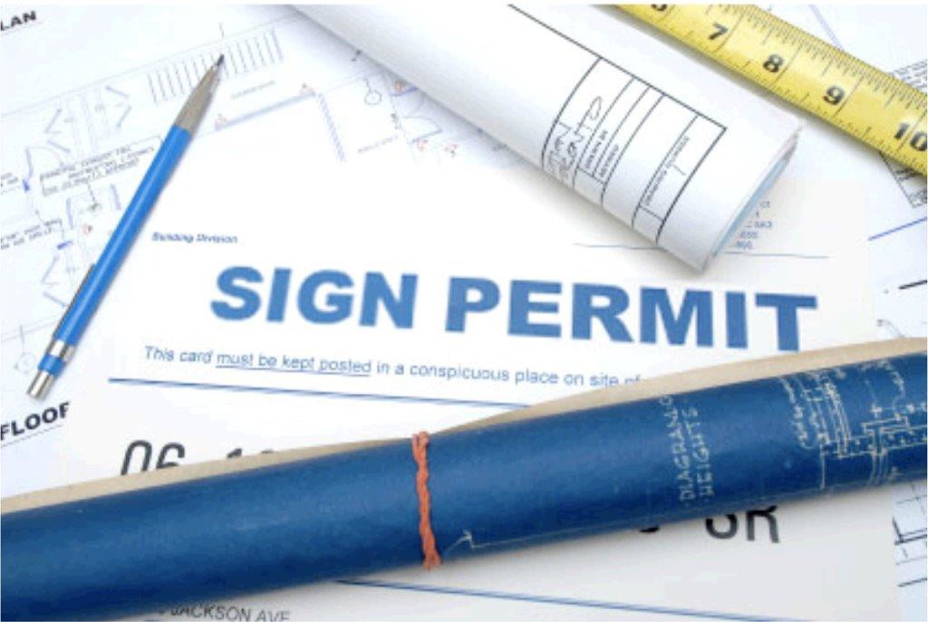Sign permit on table with ruler
