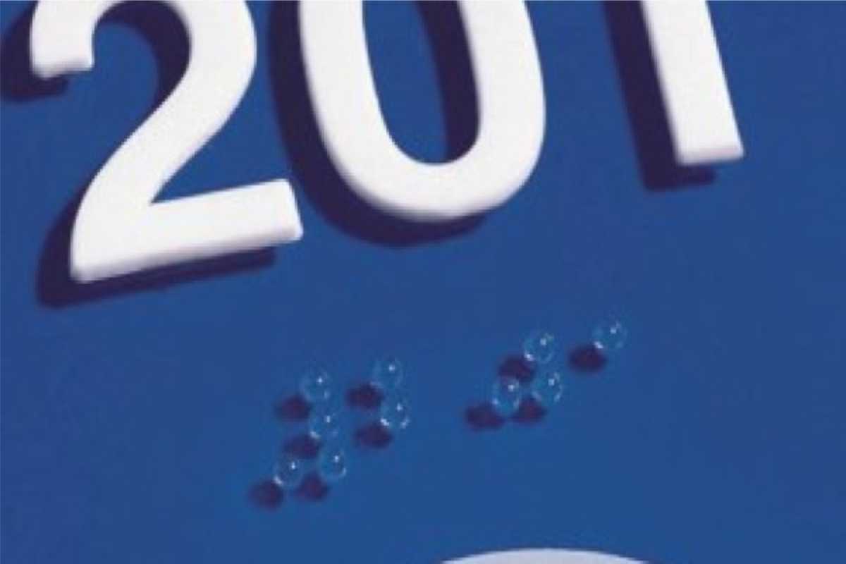 closeup of sign with braille numbers