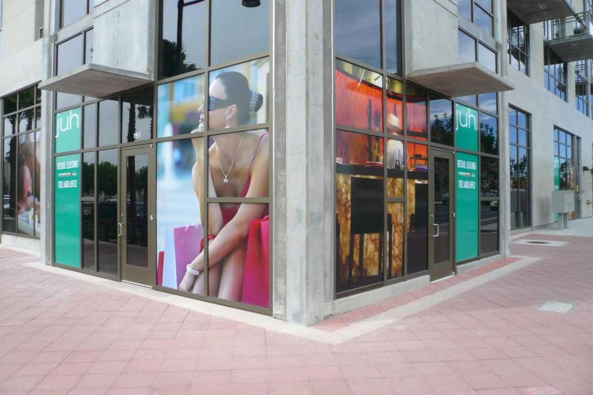 large format digital printing on street corner in window depicting woman sitting in thought