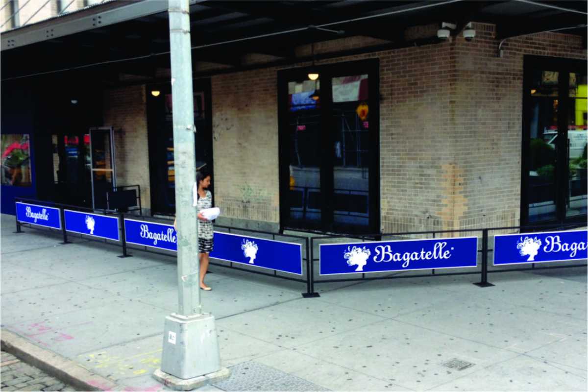 Sidewalk barriers along sidewalk outside of a store